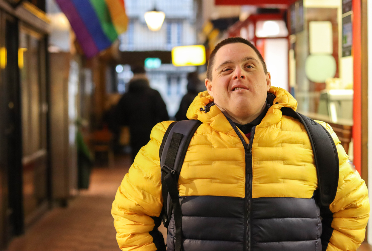 A young man with Down's syndome in an indoor market in Oxford, England